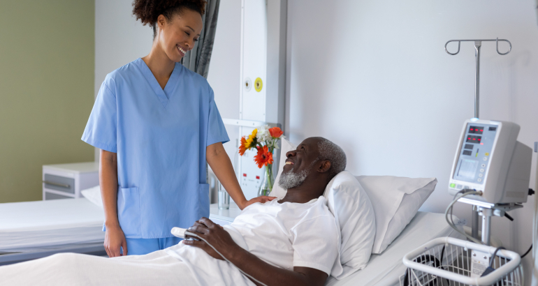 Mixed race female doctor and african american male smiling to each other in hospital patient room. medicine, health and healthcare services.