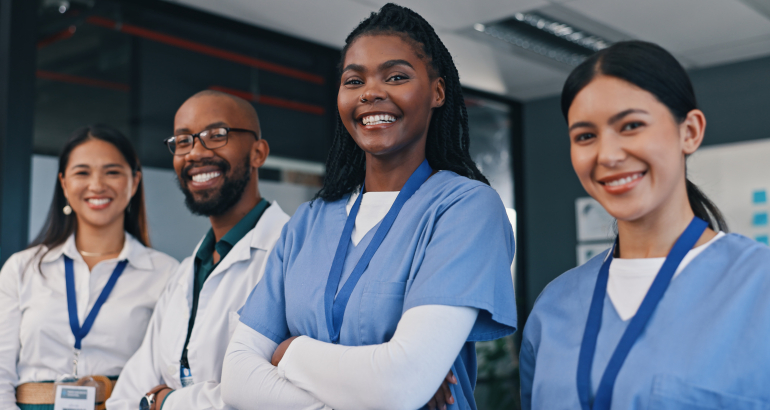 Doctors, group and happy with arms crossed in hospital with confidence in medical goals or mission